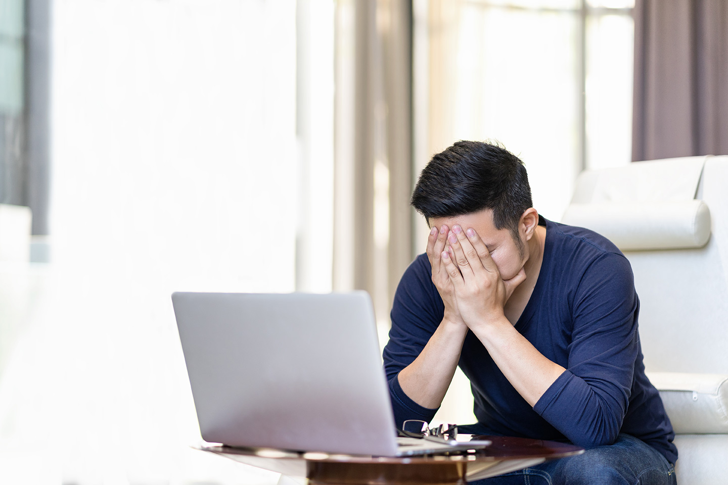 stressed-out-asian-man-freelancer-holding-hand-on-2023-11-27-05-28-22-utc.jpg